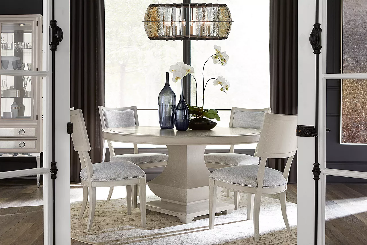 Hyde Park Round Dining Table, Dining Side Chairs, and Display Cabinet in Heather Grey in a room scene.